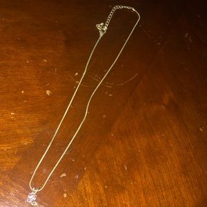 A necklace with a square pink fake diamond